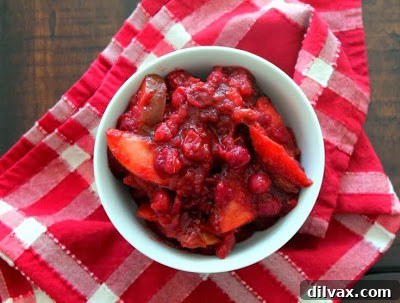 Slow cooker apple and cranberry compote, served in a bowl.