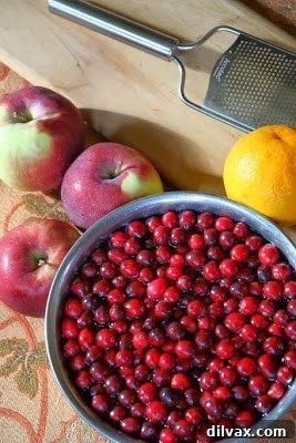 Cranberry compote with apple and orange, served in a glass bowl.