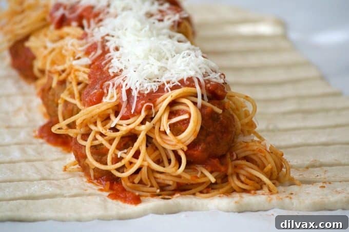 Braided Spaghetti and Meatball Bake 2 A perfectly baked Spaghetti and Meatball Braid, golden brown pizza dough encasing a hearty filling of spaghetti and meatballs. Ready to be served.