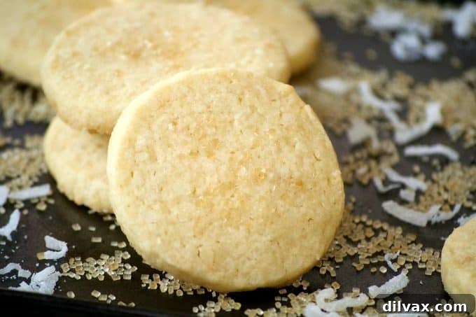 This Coconut Macadamia Nut Shortbread is a butter shortbread cookie with shredded coconut and macadamia nuts to remind you of the tropics.