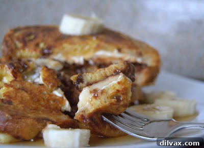 Another overhead shot of the stuffed French toast, showing the golden brown bread and a generous dusting of powdered sugar.