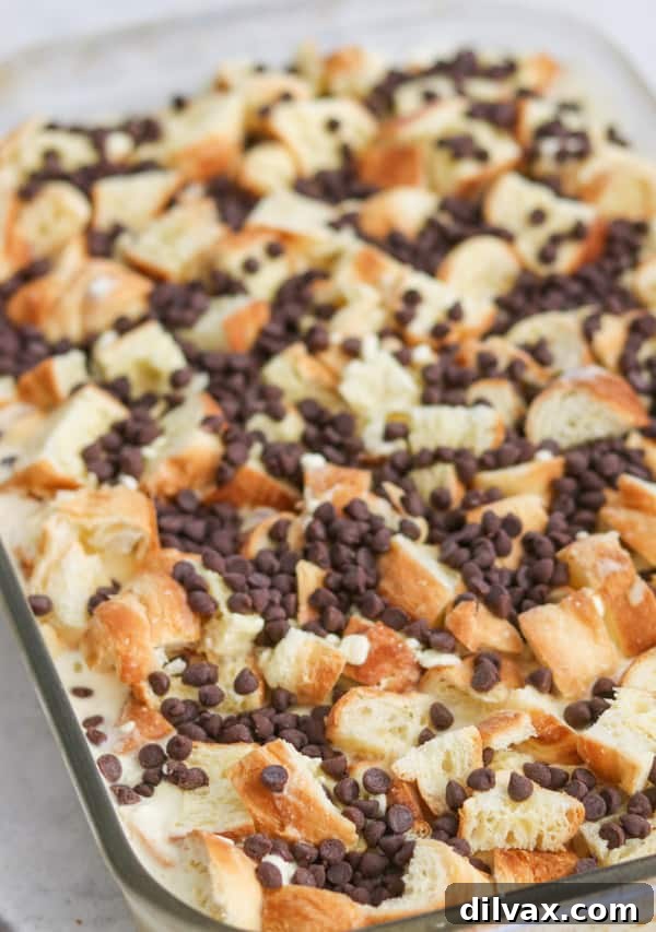 A baking dish filled with prepped Chocolate Croissant Baked French Toast, ready for the oven.