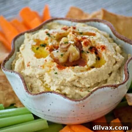 This Roasted Garlic Hummus is roasted cloves of garlic, tahini, lemon juice and spices. Served with pita chips or veggies, it's the perfect healthy treat.