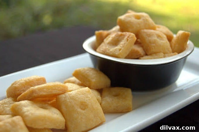 Velvety Roasted Garlic Hummus 9 Golden-brown, savory Homemade Cheese Crackers arranged artfully, showcasing their delicious texture and inviting aroma.