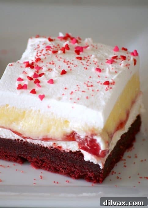 These Red Velvet Cherry Dream Bars with their red velvet cookie crust, sweet cheese layer, cherry pie filling, vanilla pudding and whipped topping make these bars the perfect holiday treat. Or better yet, enjoy them all year 'round.