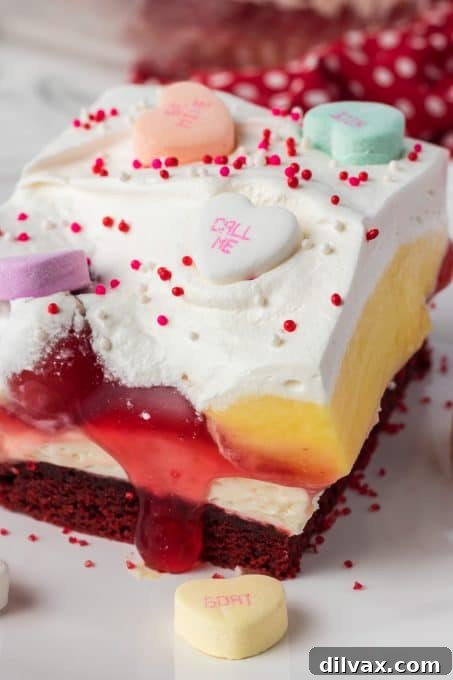 Close-up of a slice of Red Velvet Cherry Dream Bar, showing all the luscious layers.