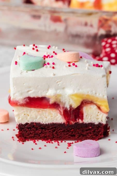 A red velvet cheesecake dessert with cherry pie filling and vanilla pudding, garnished for presentation.