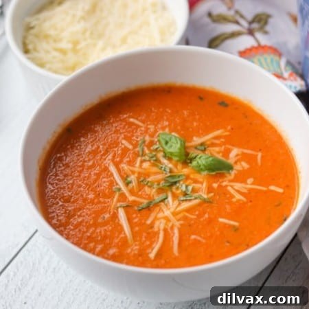 Creamy Tomato Basil Soup in a rustic white bowl