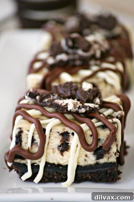 Everyone will love these Cookies and Cream Cheesecake Bars with their Oreo cookie crust, cookies and cream cheesecake layer and drizzled with chocolate.