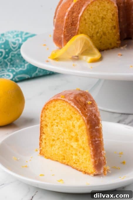 Gigi's Effortless Lemon Cake 11 A generous slice of Easy Lemon Cake presented on a white plate, perfect for a casual party or gathering.
