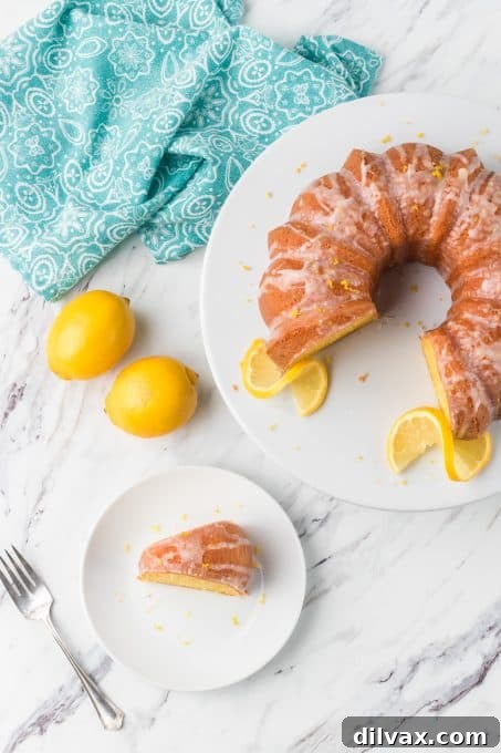 Gigi's Effortless Lemon Cake 9 An inviting overhead shot of the fully glazed Easy Lemon Cake, garnished with fresh lemon slices and mint leaves, showcasing its delightful appeal.