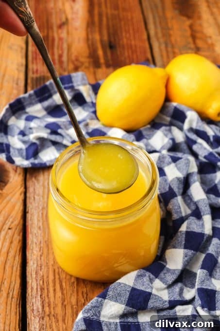 Fresh lemon juice being poured, essential for vibrant curd