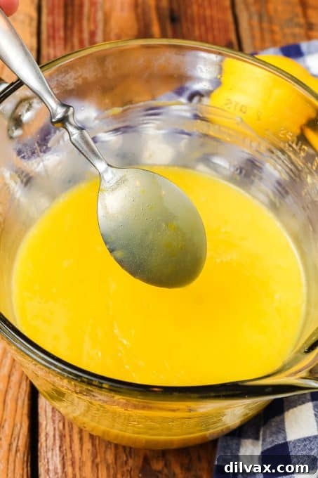 Checking the thickness of homemade lemon curd on a spoon