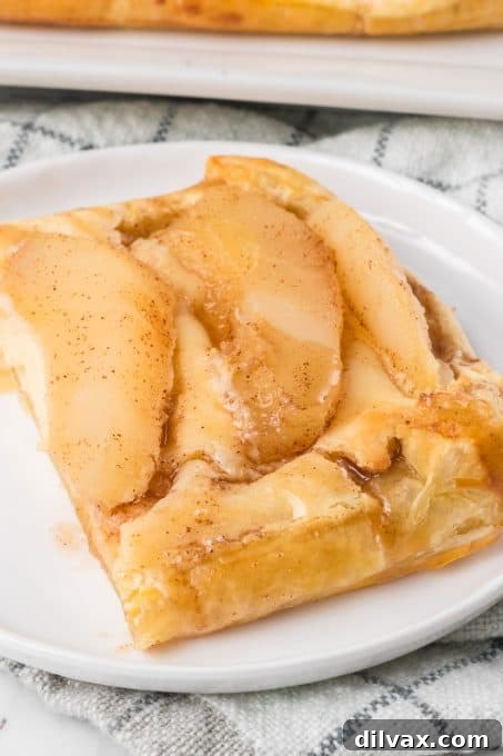 Pear slices gracefully topping a sweet cream Danish