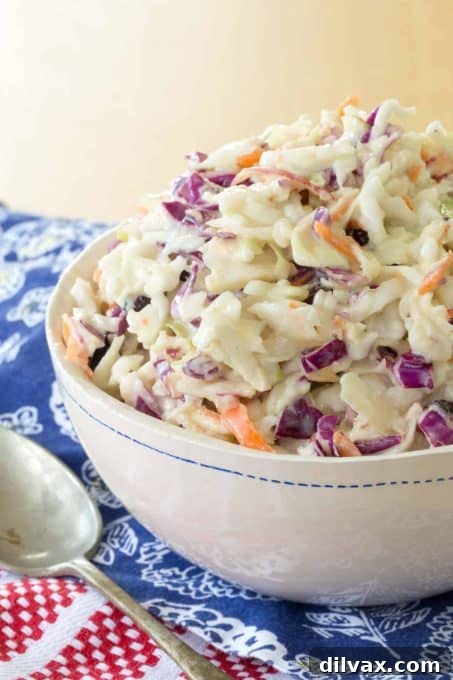 A fresh and crisp Maple Dijon Apple Coleslaw in a serving bowl, perfect for summer potlucks.