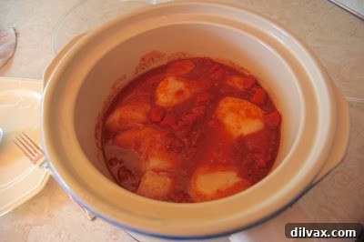 Slow Cooker Zesty Taco Chicken 4 Chicken breasts rubbed with taco seasoning in a slow cooker