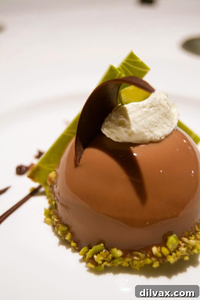 Indulge in the decadent Chocolate Pistachio Dome, a memorable dessert highlight from dining on the Coral Princess.