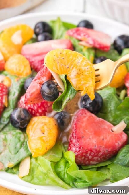A vibrant strawberry spinach salad with pecans and a light vinaigrette.