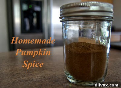 Freshly baked pumpkin spice oatmeal drop cookies cooling on a wire rack, sprinkled with a hint of spice.