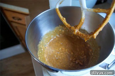 A medium bowl containing sifted dry ingredients: flour, salt, baking soda, and pumpkin spice.