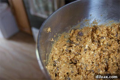 Cookie dough scooped onto a parchment-lined baking sheet, spaced for baking.
