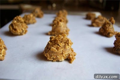 Freshly baked pumpkin spice oatmeal cookies, golden brown and perfectly set, on a baking sheet.