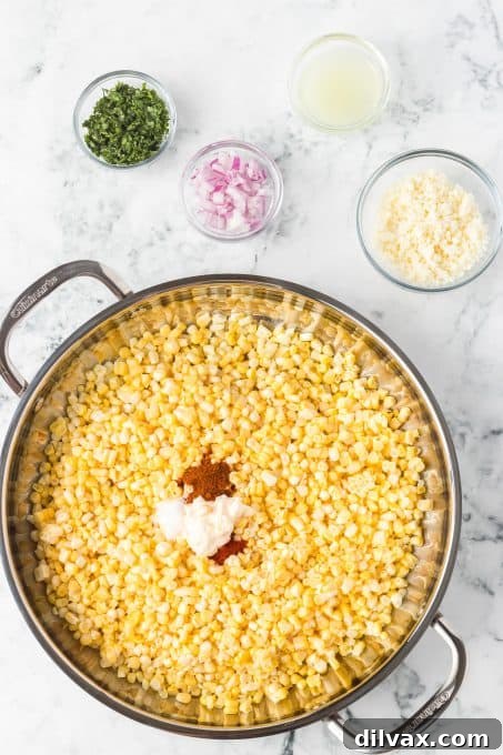 One-Pan Mexican Street Corn 6 Process shot showing corn being cooked in a skillet for Mexican Street Corn