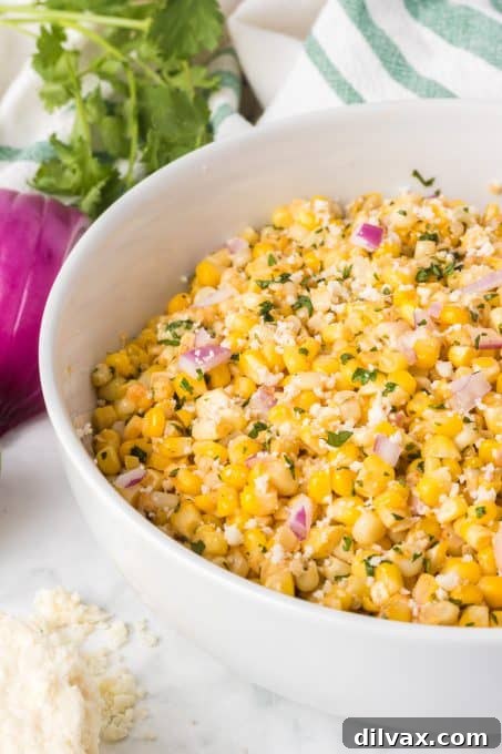 One-Pan Mexican Street Corn 9 A delicious Mexican Street Corn made in a skillet, served in a bowl with lime wedges.