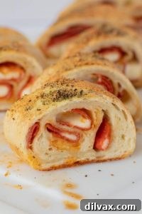 Game Day Delights 3 Close-up shot of freshly baked pepperoni bread, showing golden crust and slices revealing generous amounts of pepperoni and melted cheese, perfect for a Game Day snack.