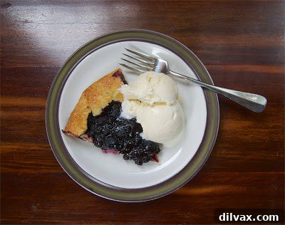 Rustic Blueberry Ginger Galette 7 The rustic galette crust being folded over the blueberry and ginger filling.