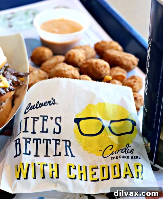 National Cheese Curd Day: Celebrate at Culver's 7 A collection of Culver's signature dipping sauces displayed prominently next to a serving of golden cheese curds