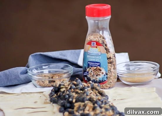 Creamy Blueberry Ginger Danish 4 A vibrant Blueberry Ginger Cheese Danish slice, adorned with the delightful crunch and flavor of McCormick® Good Morning Blueberry Ginger Breakfast Toppers. A perfect morning indulgence.