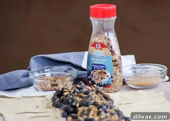 Ginger-Kissed Blueberry Cream Danish 4 A selection of breakfast options, including the featured Blueberry Ginger Cheese Danish, a bowl of yogurt with fruit, and a side of fresh blueberries. All are ready to be enhanced with the versatile McCormick® Good Morning Breakfast Toppers, showcasing their ease of use and ability to elevate any morning meal.