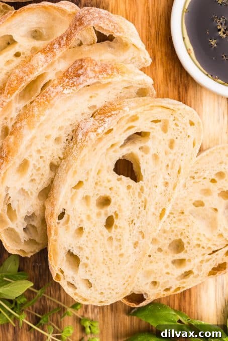 Two golden-brown loaves of Ciabatta Bread cooling on a wire rack.