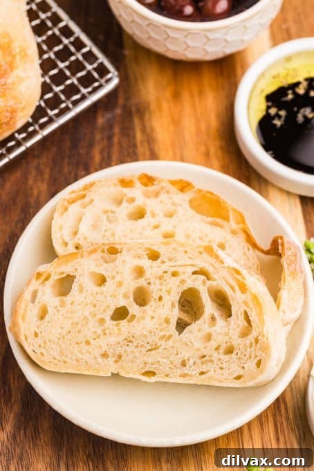 Two perfectly sliced pieces of Ciabatta bread on a plate, ready to be enjoyed.