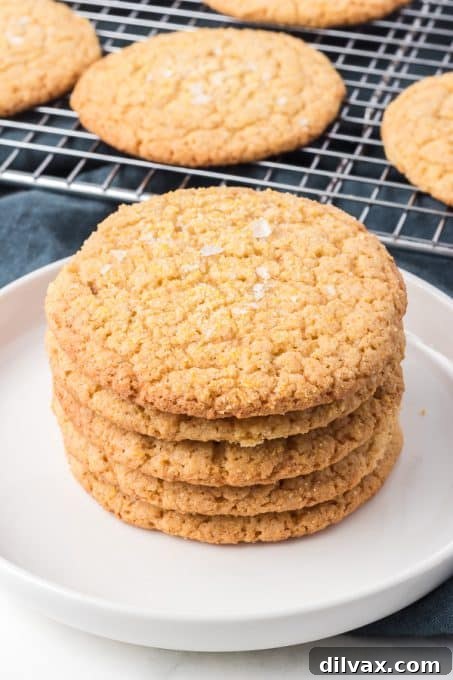 A perfectly arranged stack of Cornmeal Cookies on a white plate, ready to be served.