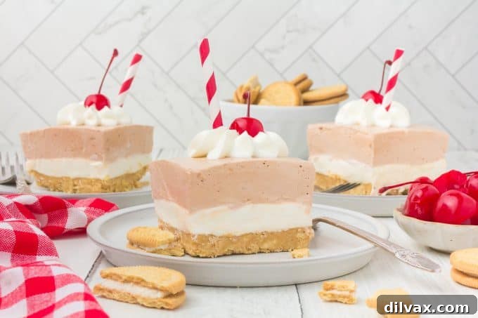 Slices of a lasagna dessert on plates with drinking straws as decoration surrounded by Golden Oreos, cherries and a red and white checkered napkin.