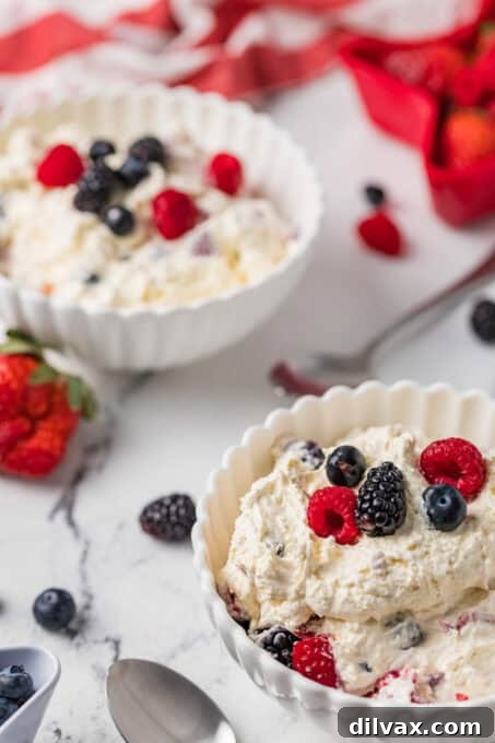 Two bowls of berries mixed with cheesecake.