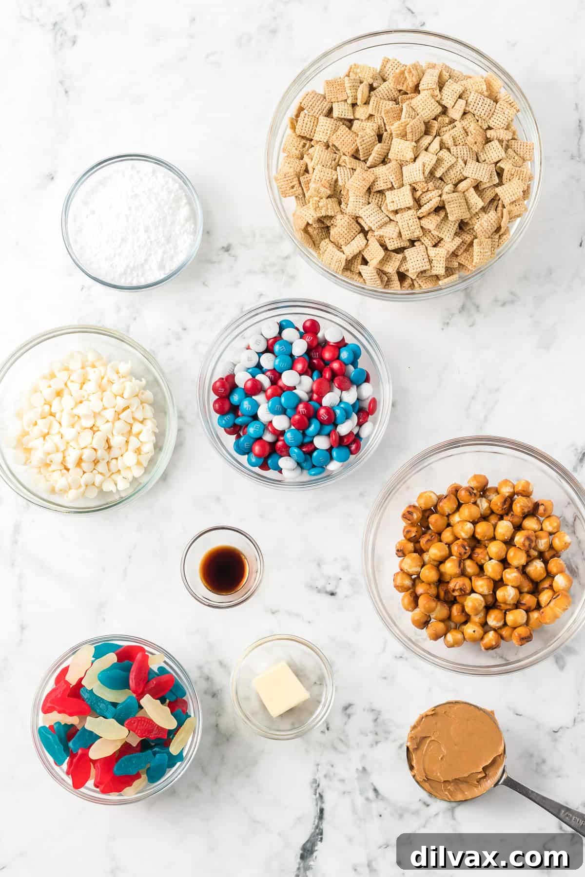 Bowls of ingredients for a Patriotic Chex Mix.