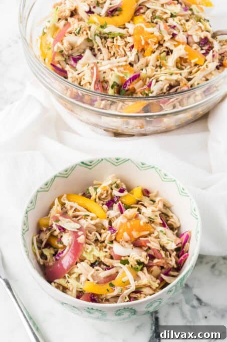 Two bowls full of Ramen Noodle Salad tossed with a ginger dressing.