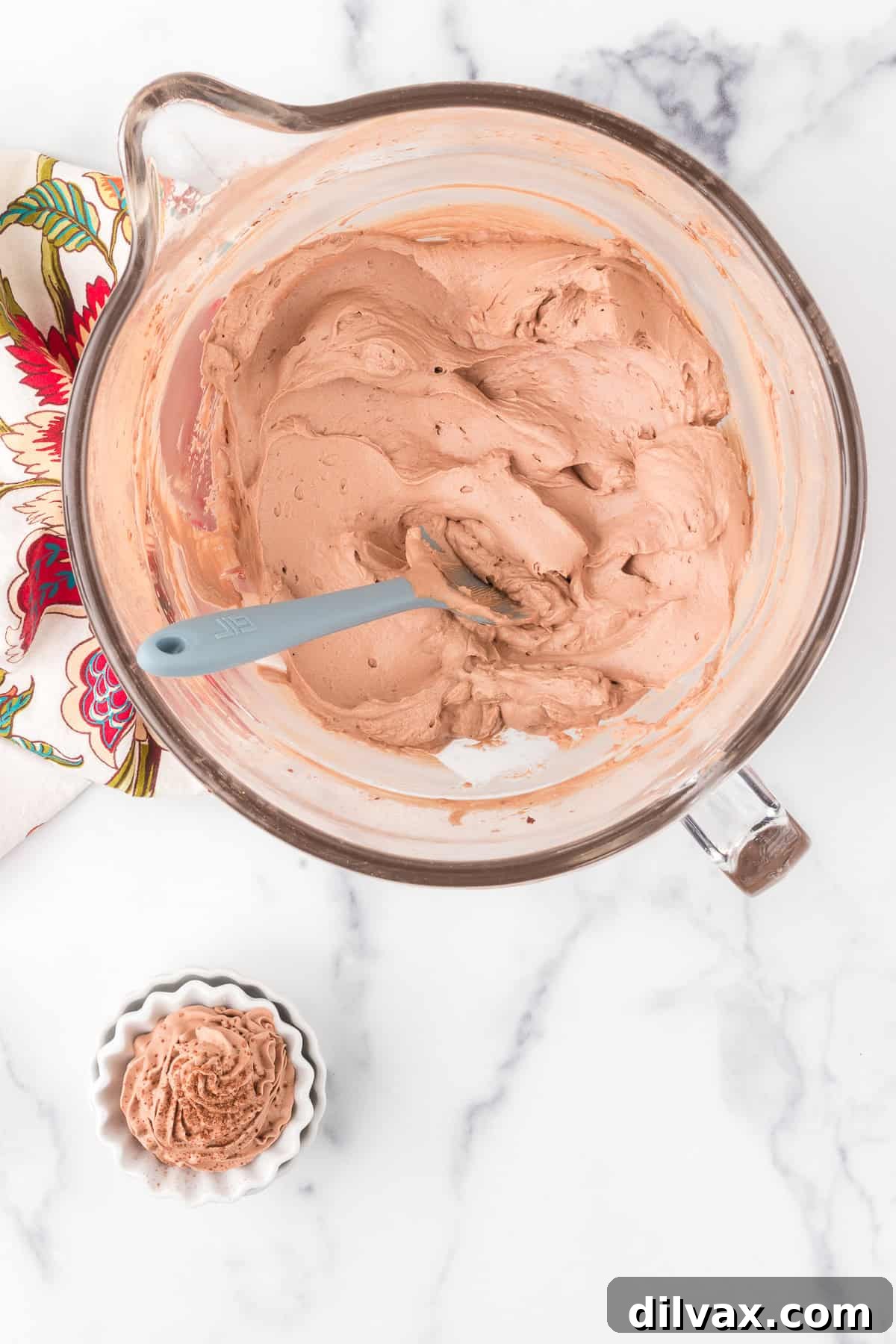 Chocolate whipped cream in a mixing bowl and in a small serving bowl.