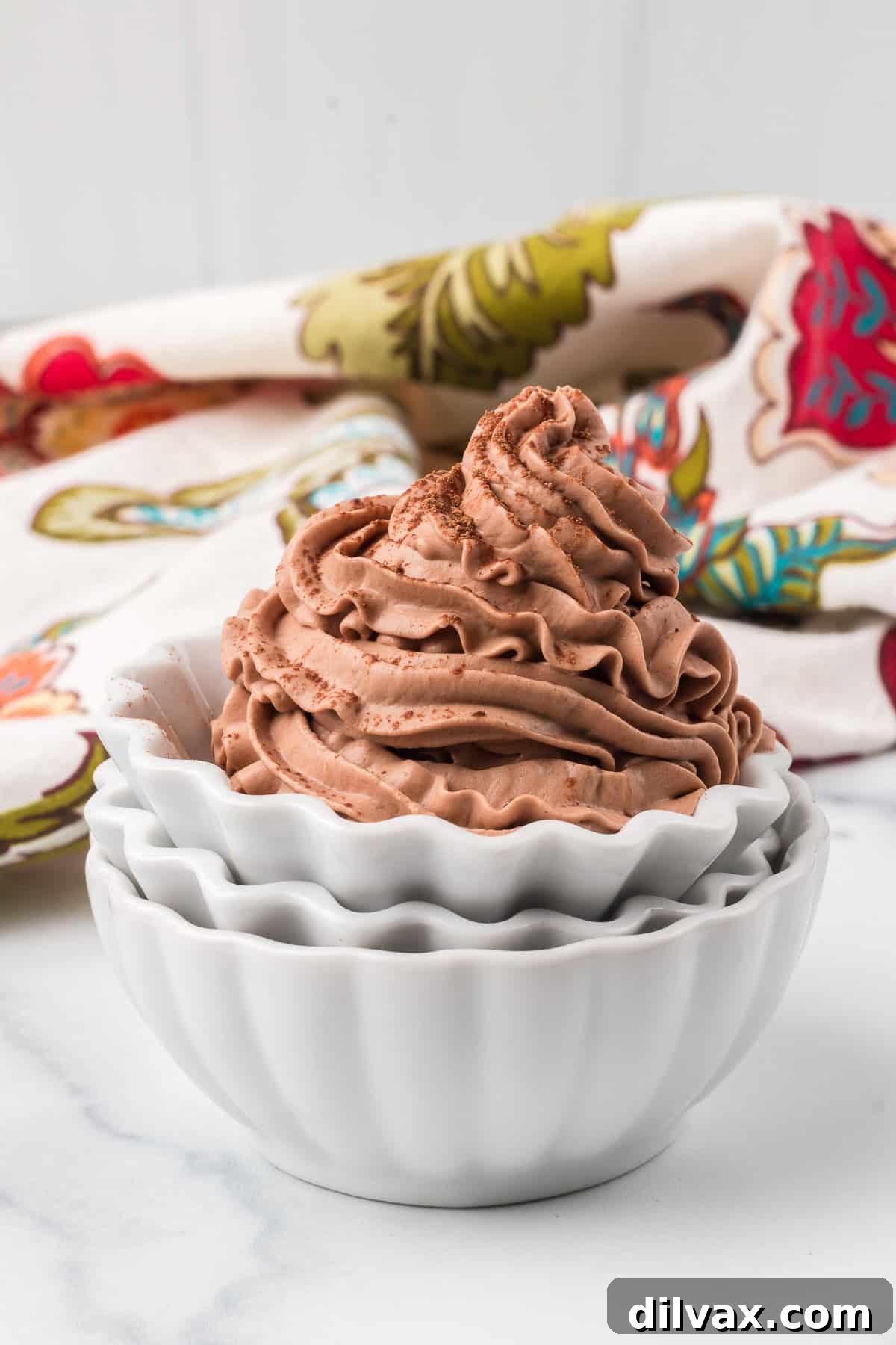 Piped chocolate cream for desserts in a stack of serving bowls.