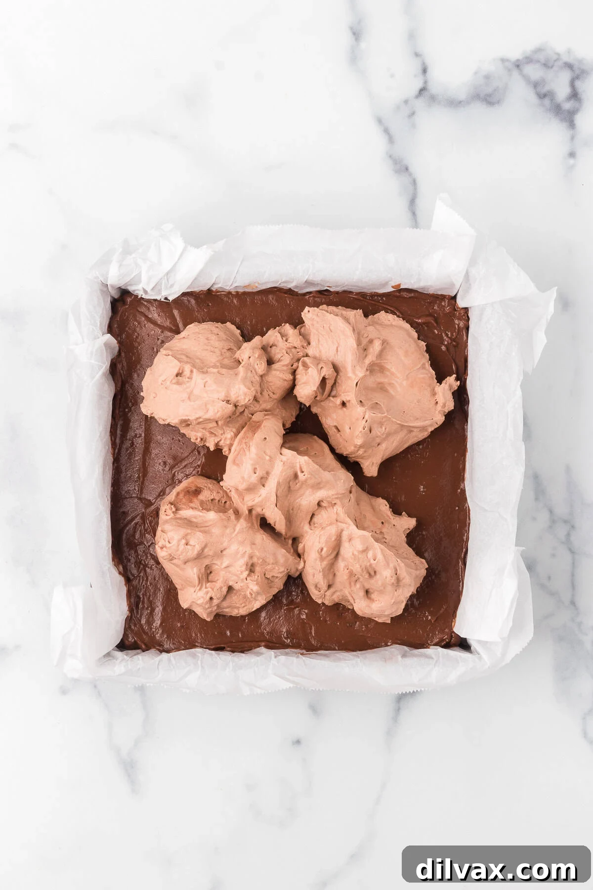 Stabilized Chocolate Whipped Cream on ready to be spread on no bake chocolate bars.