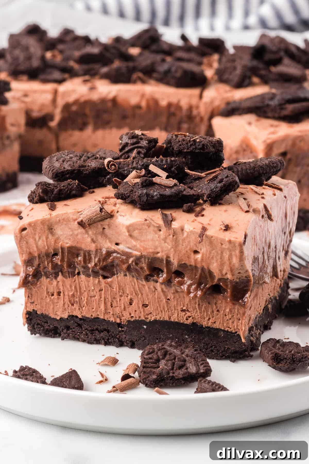 Chocolate layers on top of an Oreo crust on a plate.