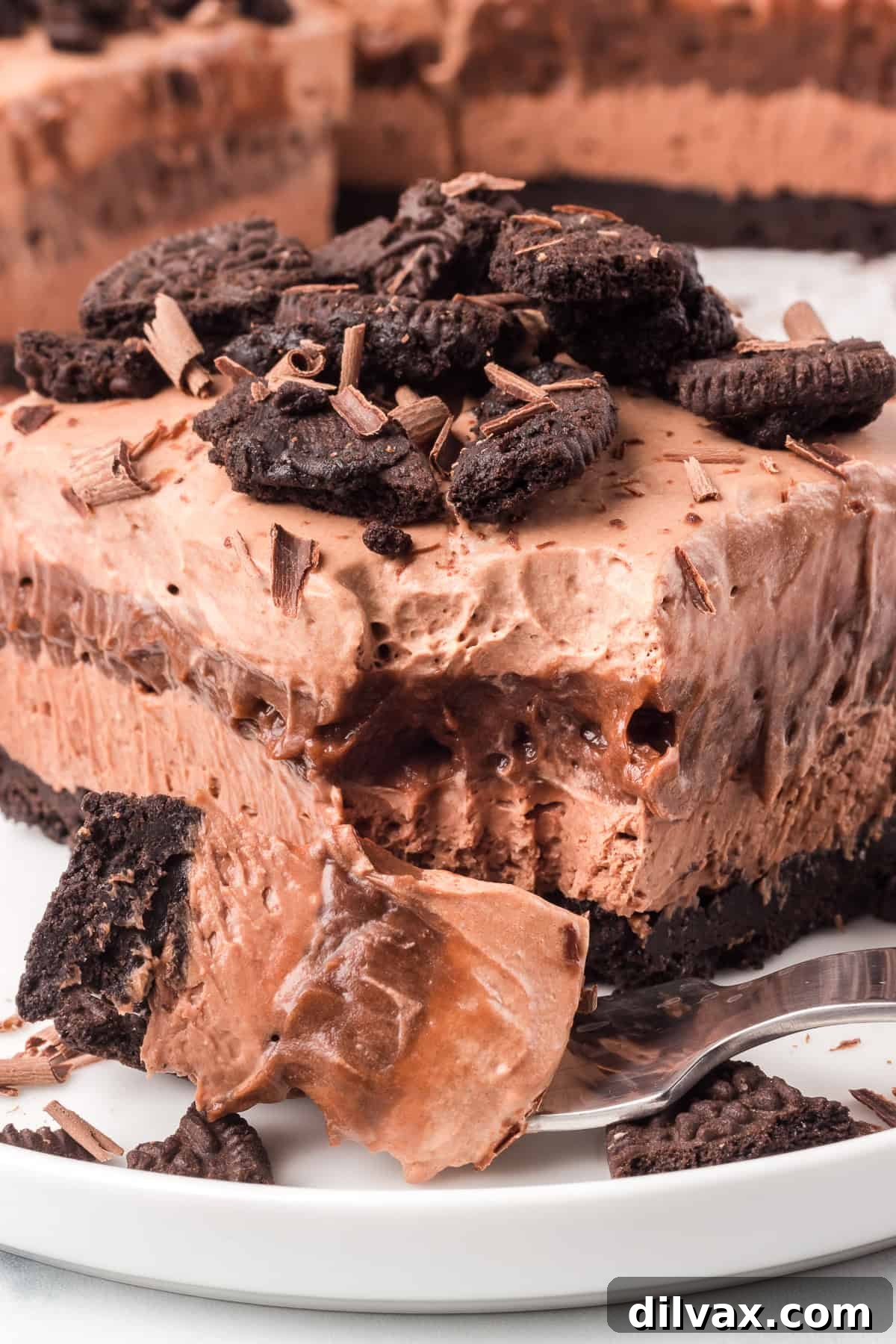 A bite taken out of a no bake chocolate layered dessert.