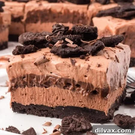 Chocolate layers on top of an Oreo crust on a plate.