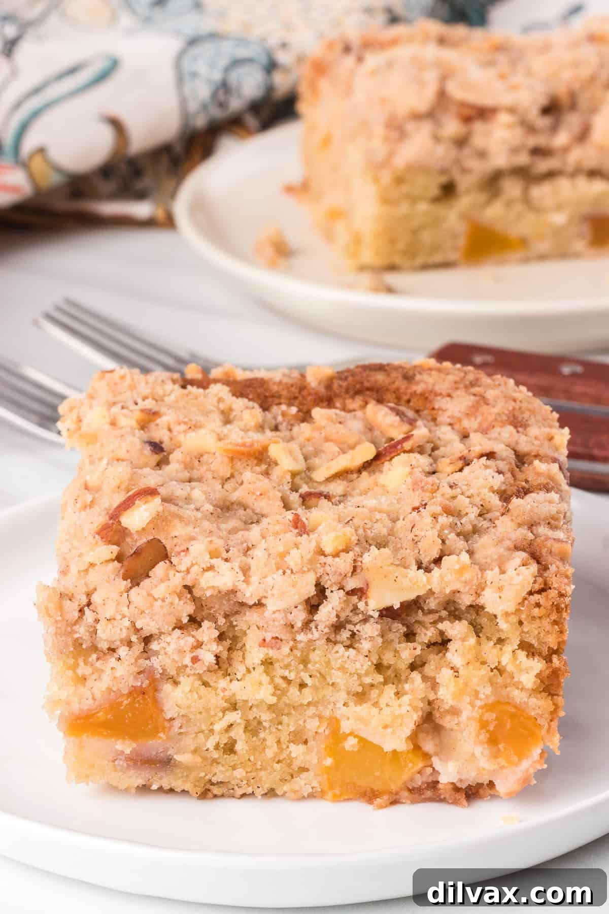 Slices of peach cake on plates with a floral napkin